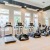 Fitness center at our active adult community in Davenport, FL, featuring wood grain floor paneling and exercise bikes.